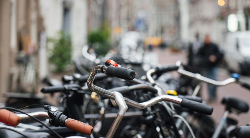 Photo prise dans la rue où on voit des vélos stationnés sur le bas côté
